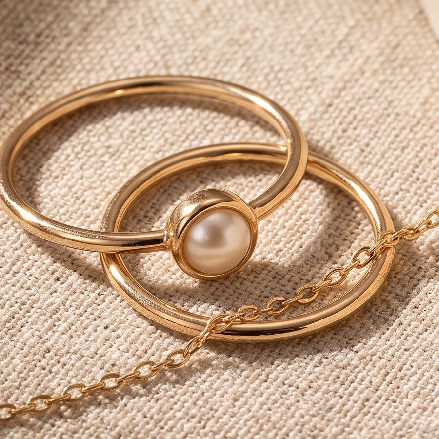 Gold rings and pearl on linen