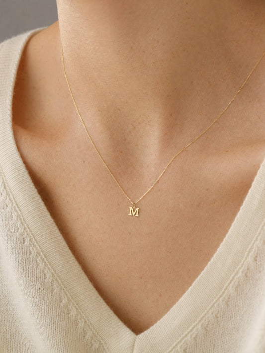 SAINT GILD initial necklace on neck