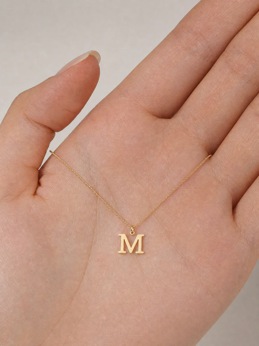 SAINT GILD initial necklace in hand