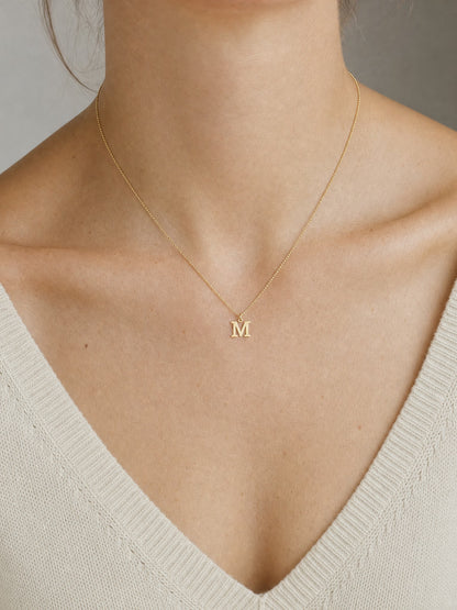 SAINT GILD initial necklace worn on body