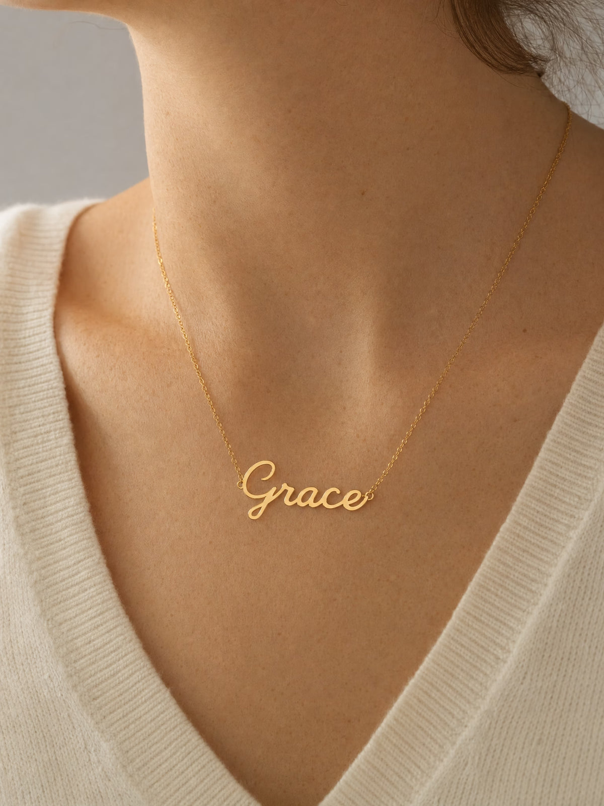 SAINT GILD name necklace on neck