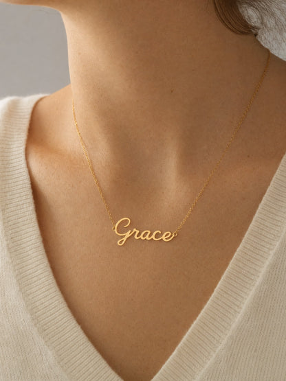 SAINT GILD name necklace on neck