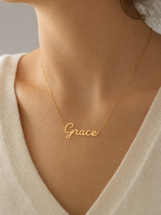 SAINT GILD name necklace on neck