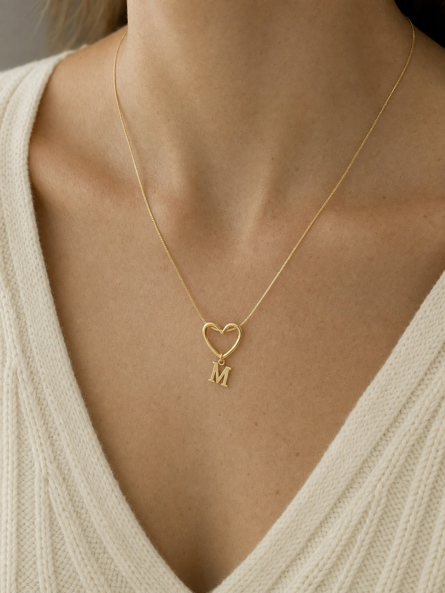 SAINT GILD initial heart necklace on neck