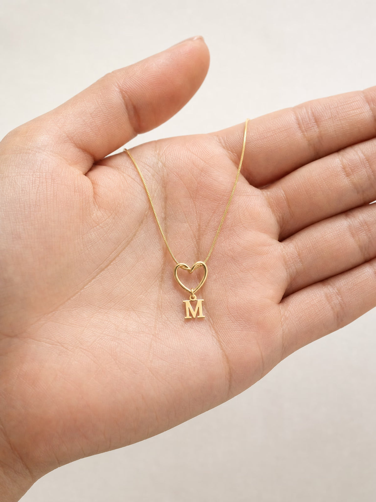 SAINT GILD initial heart necklace in hand