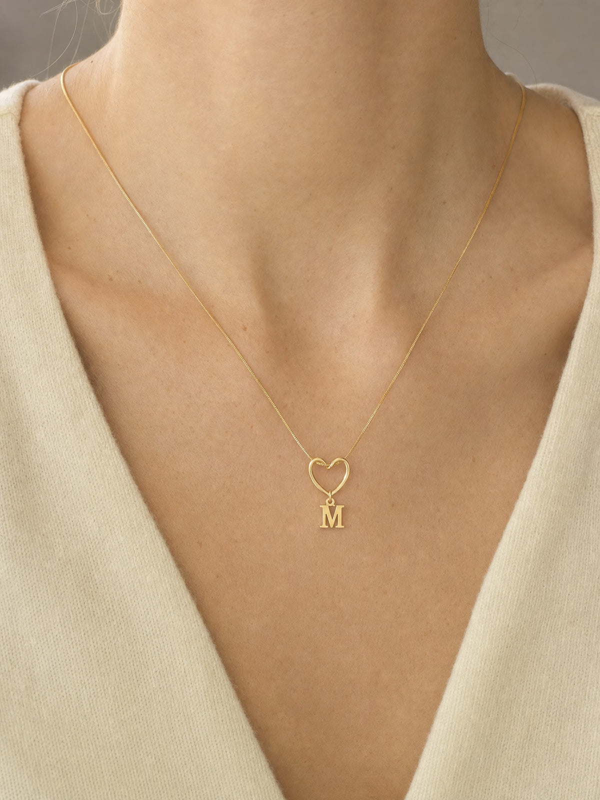 SAINT GILD initial heart necklace worn on body