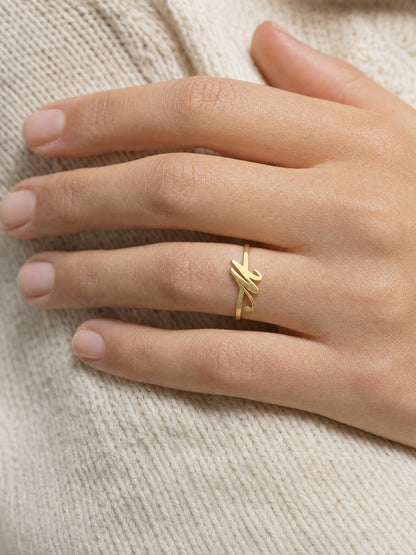 SAINT GILD initial ring on finger
