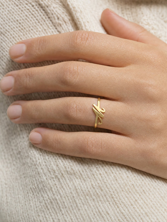 SAINT GILD initial ring on finger