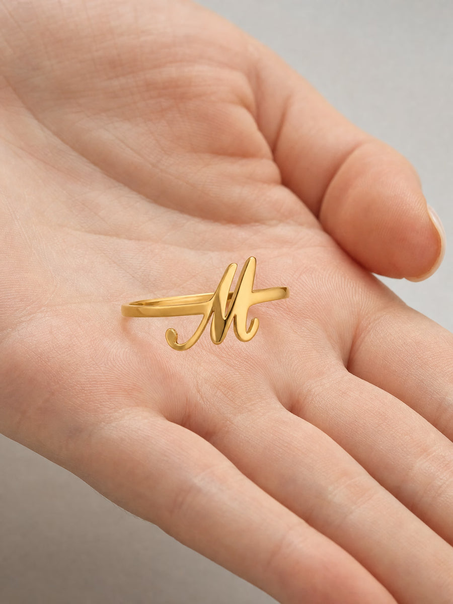SAINT GILD initial ring in hand