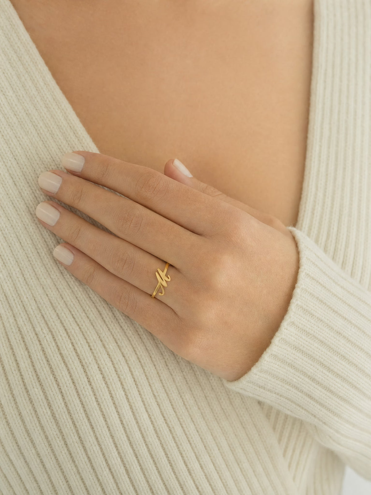 SAINT GILD initial ring worn on body