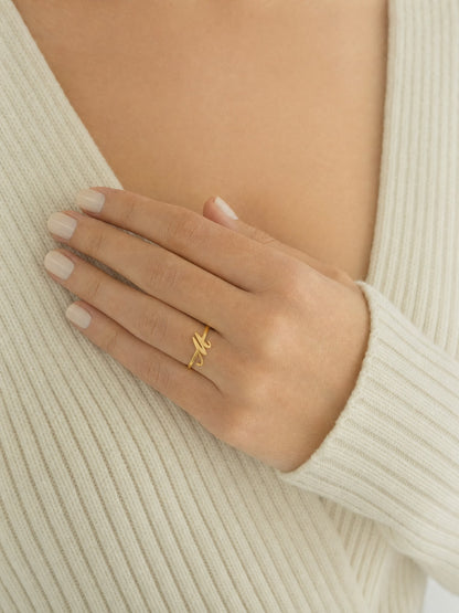 SAINT GILD initial ring worn on body