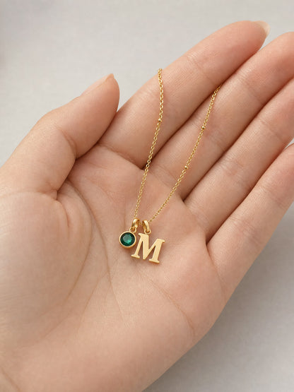SAINT GILD initial birthstone necklace in hand