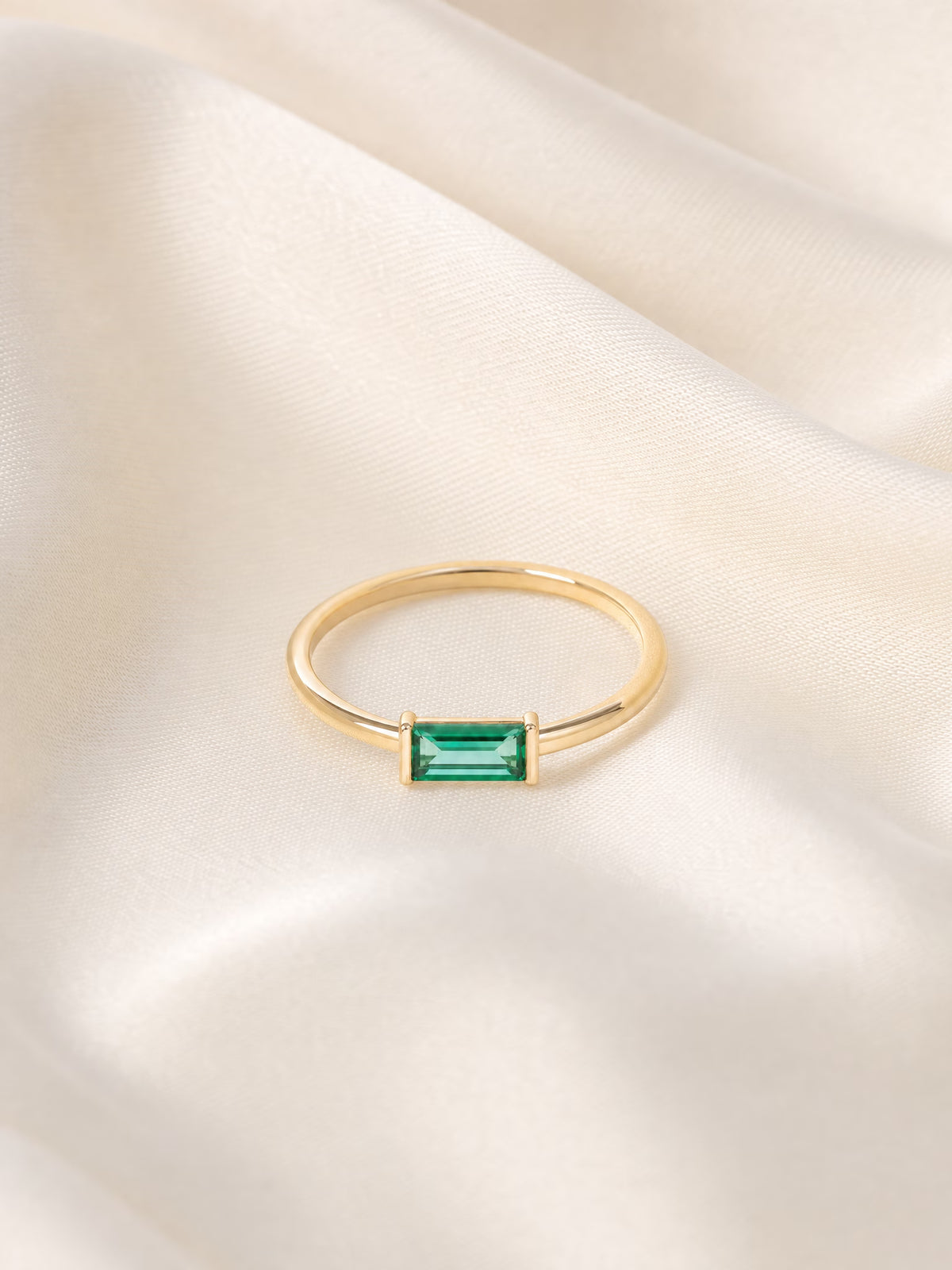 SAINT GILD birthstone ring flatlay on satin