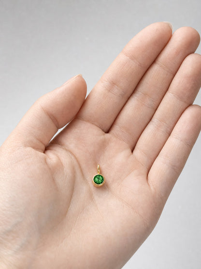 SAINT GILD birth month charm in hand