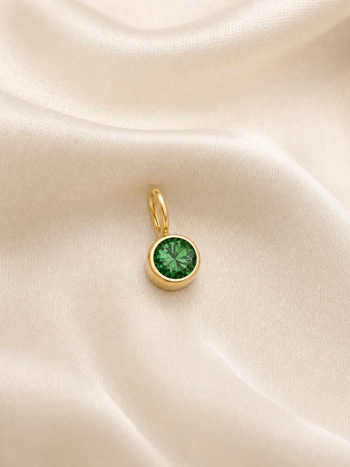 SAINT GILD birth month charm flatlay on satin