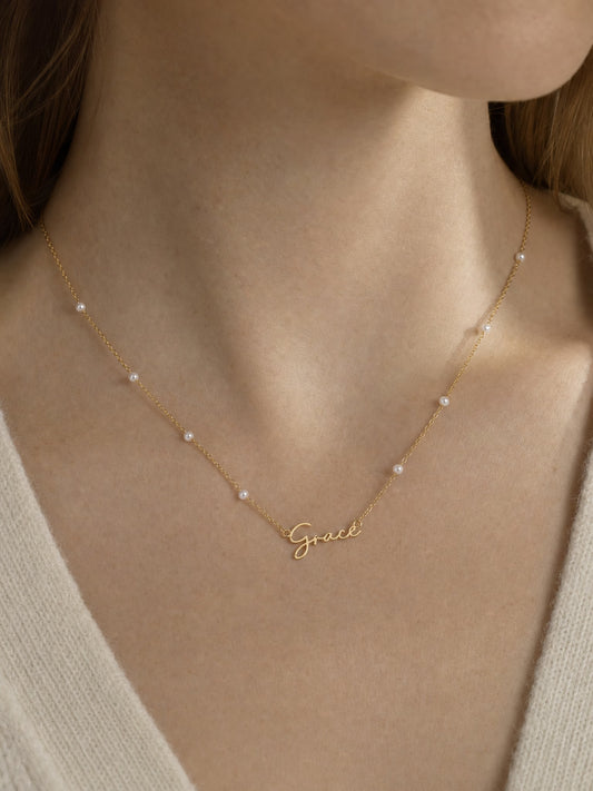 SAINT GILD faux pearl name necklace on neck