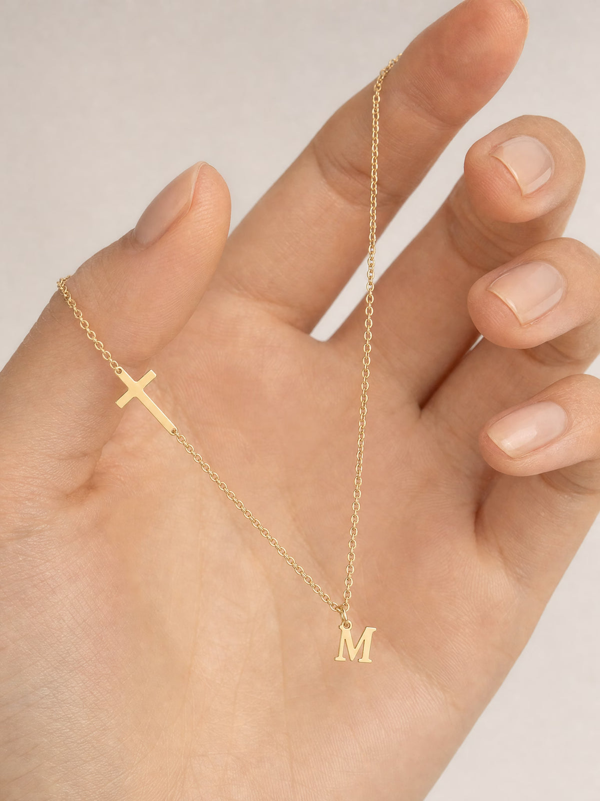 SAINT GILD initial cross necklace in hand