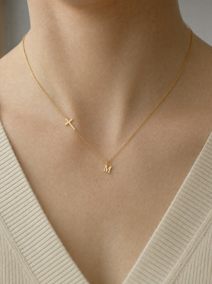 SAINT GILD initial cross necklace worn on body