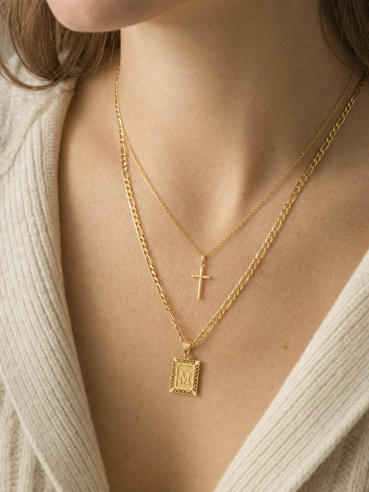 SAINT GILD initial cross necklace set on neck