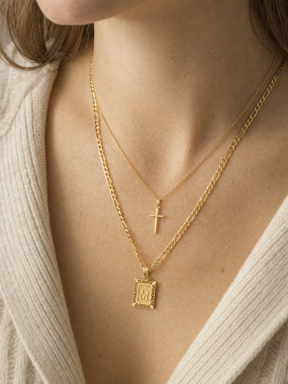 SAINT GILD initial cross necklace set on neck
