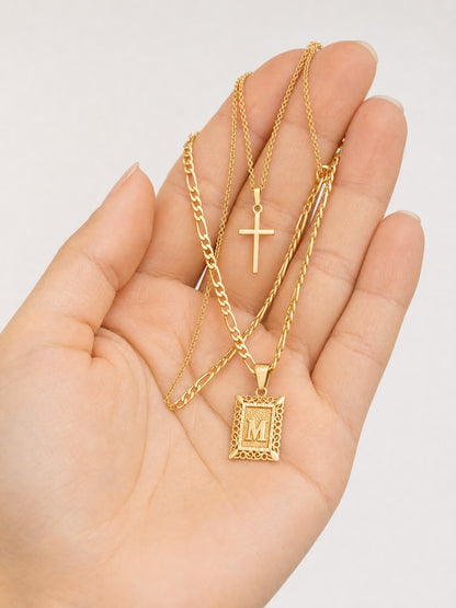 SAINT GILD initial cross necklace set in hand