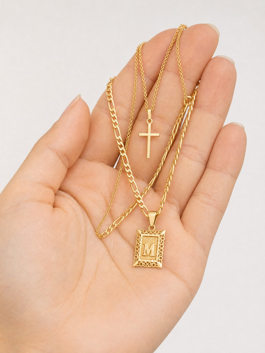 SAINT GILD initial cross necklace set in hand
