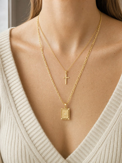 SAINT GILD initial cross necklace set worn on body
