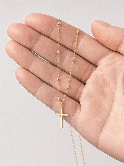 SAINT GILD Beaded Cross Necklace in hand
