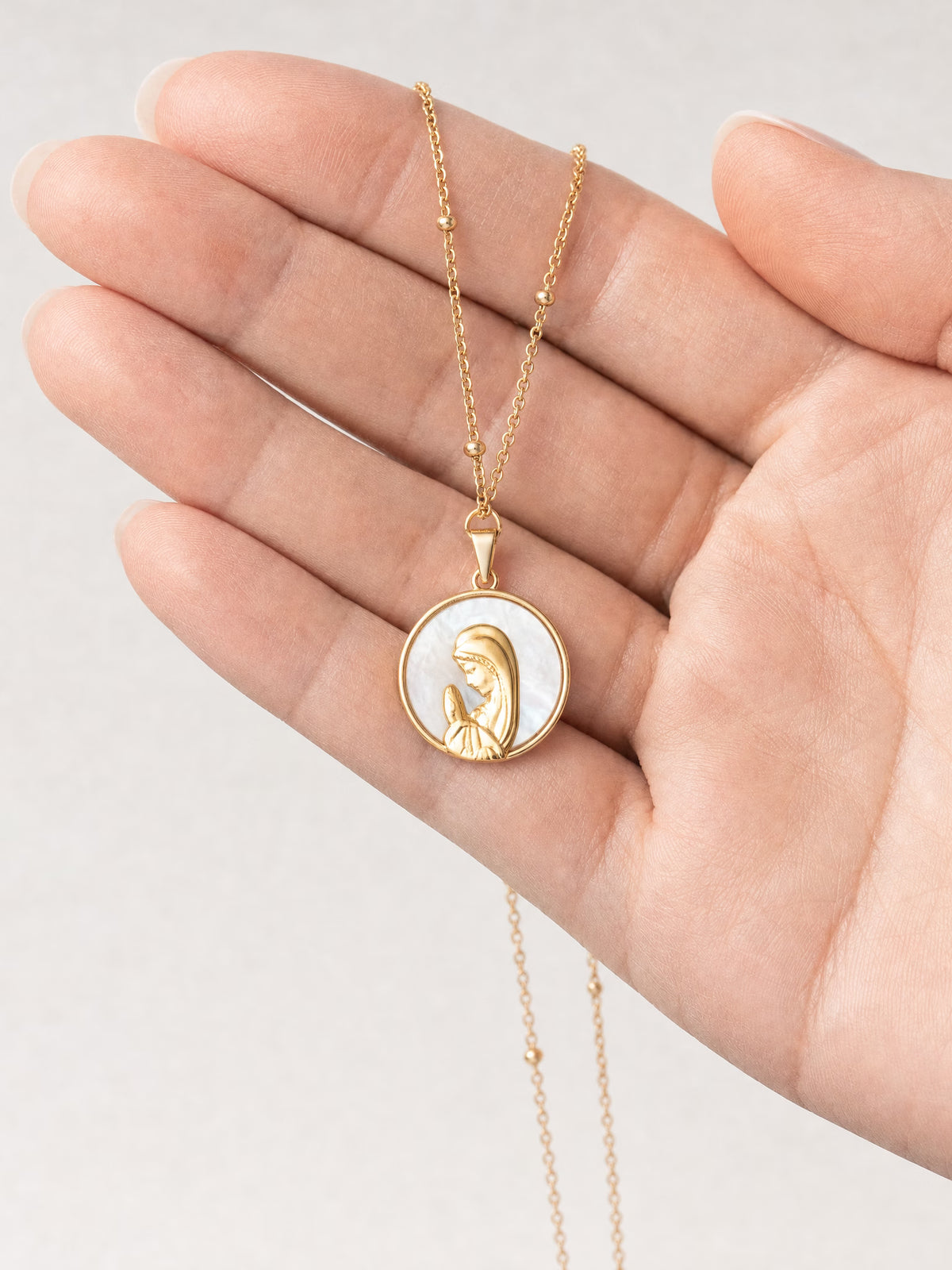 SAINT GILD Mother Mary Necklace in hand