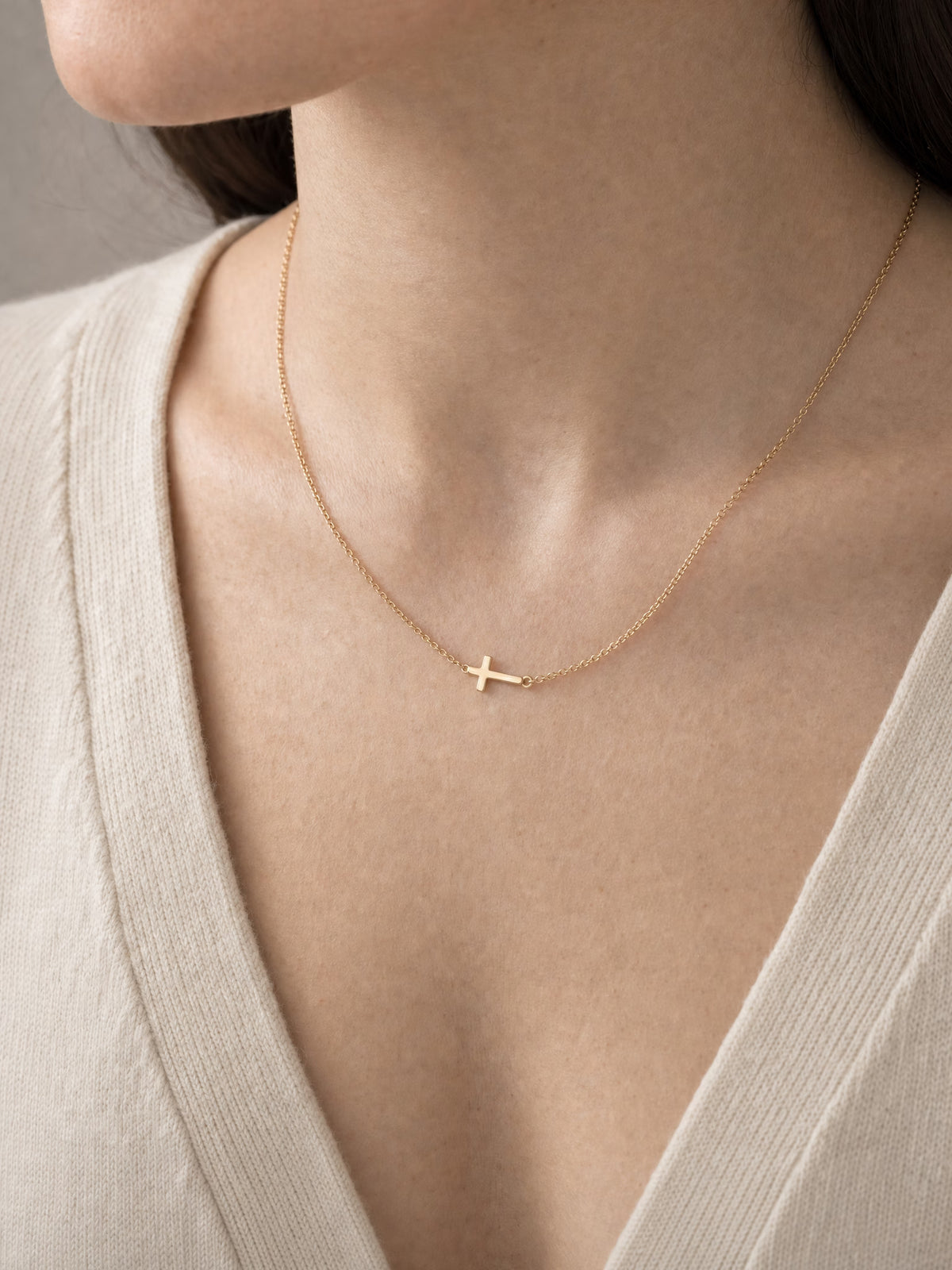 SAINT GILD Sideways Cross Necklace on neck