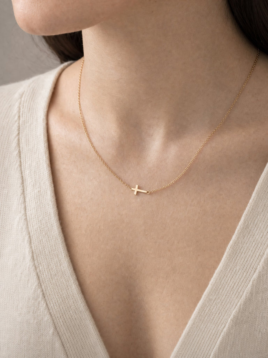 SAINT GILD Sideways Cross Necklace on neck