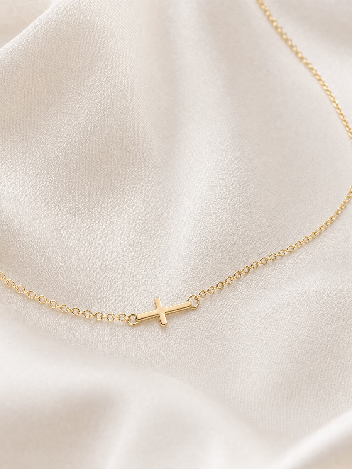 SAINT GILD Sideways Cross Necklace on satin