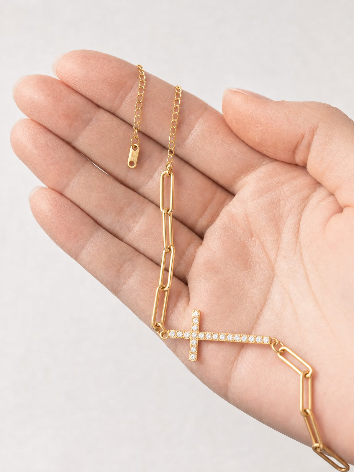 SAINT GILD Cross Station Bracelet in hand