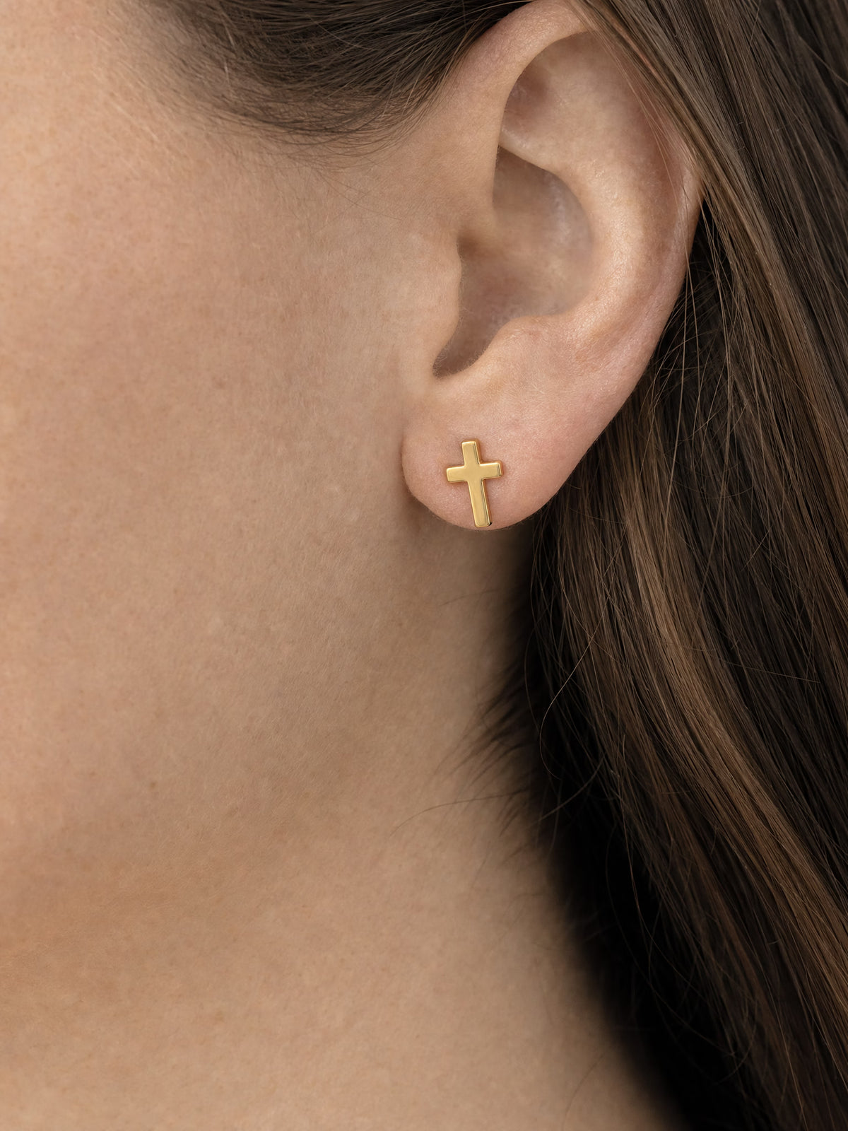 SAINT GILD Cross Stud Earrings on ear