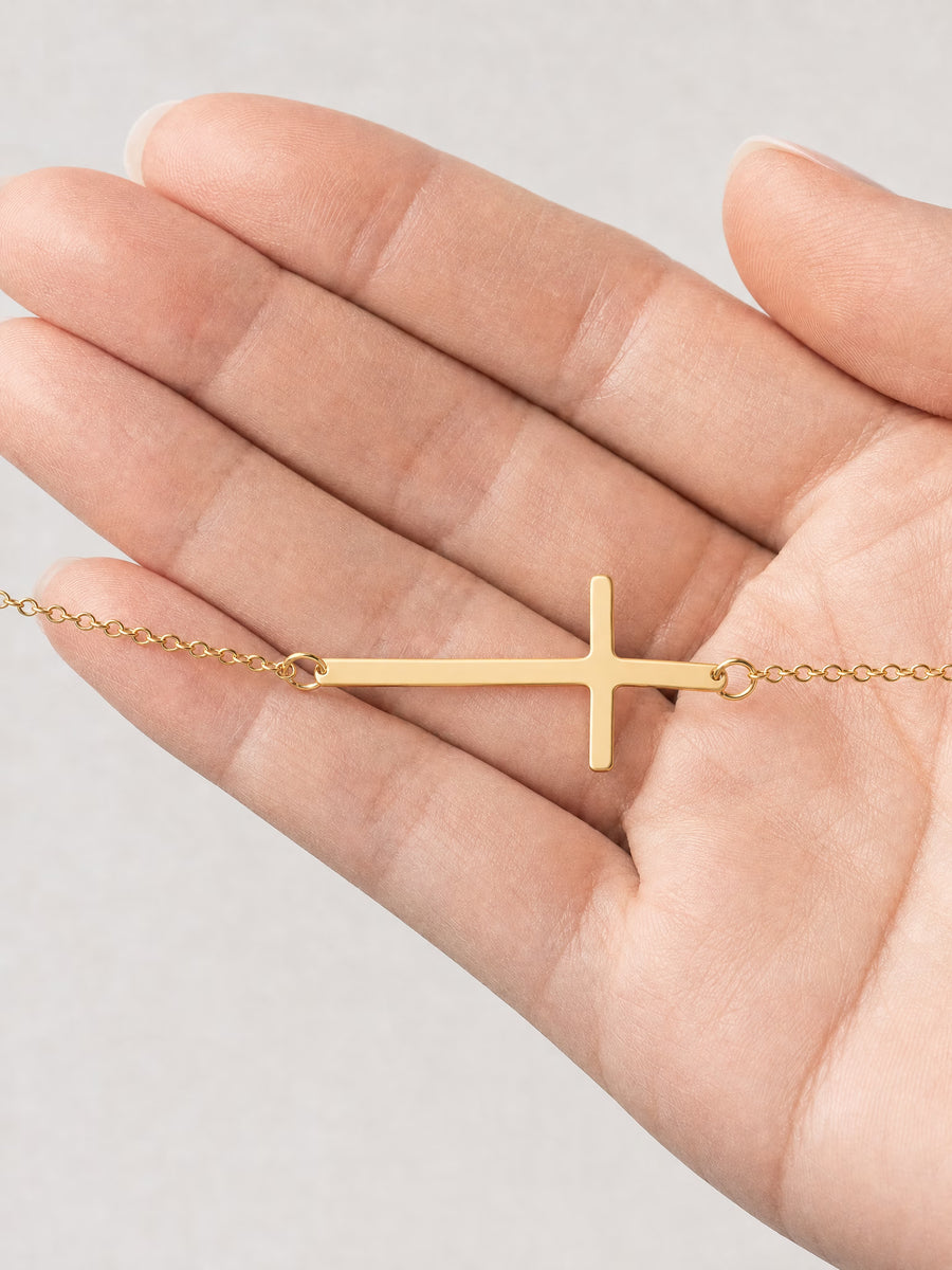 SAINT GILD Sideways Cross Bracelet in hand