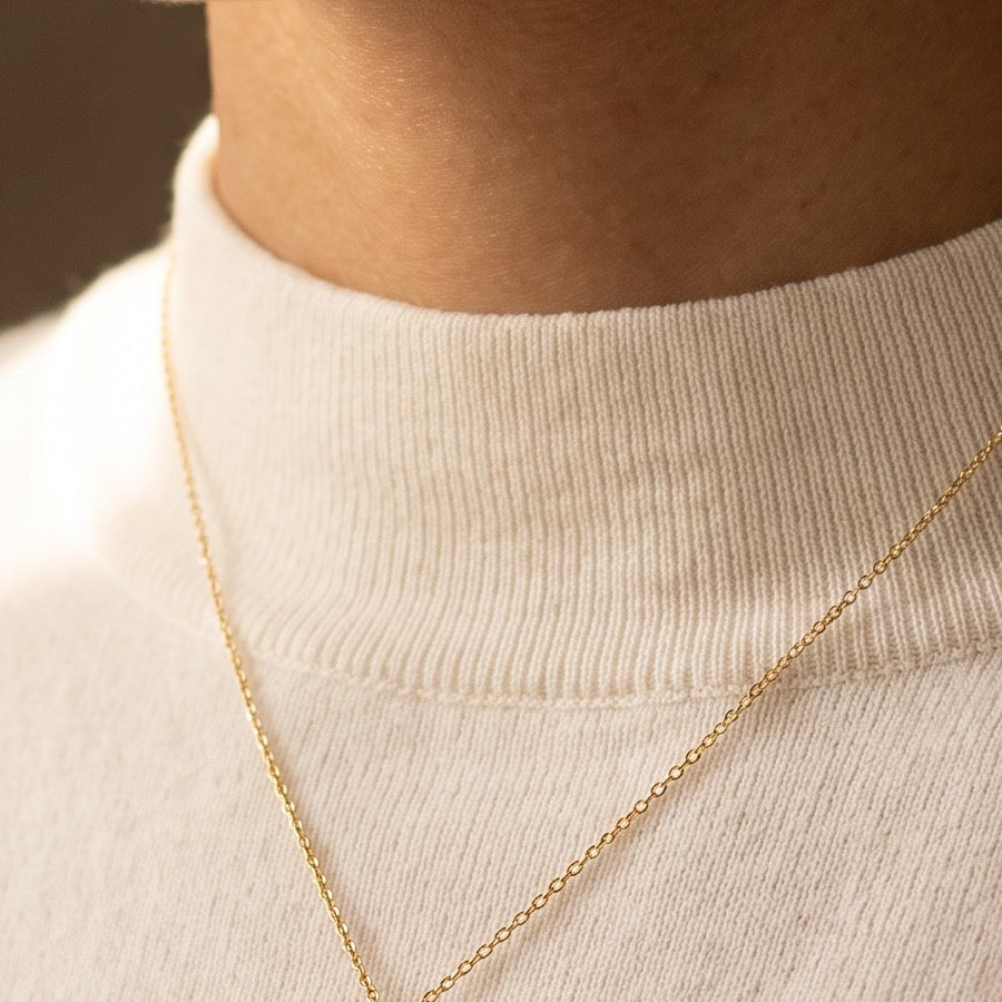 Gold cross at the neckline